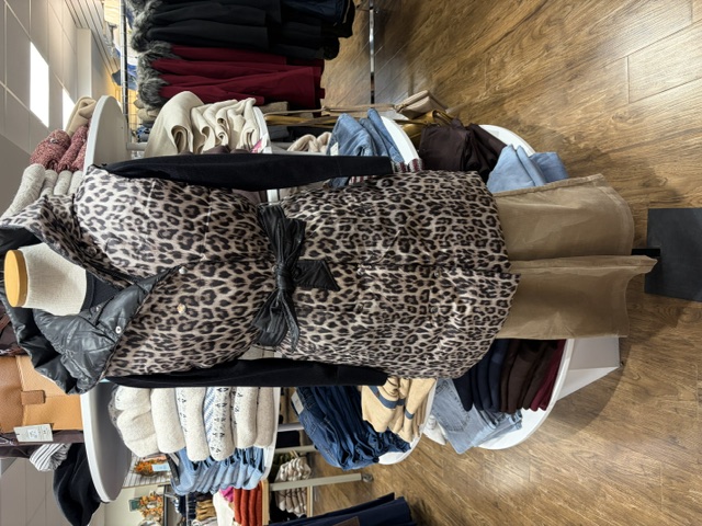 Long belted leopard-print puffer vest on a mannequin