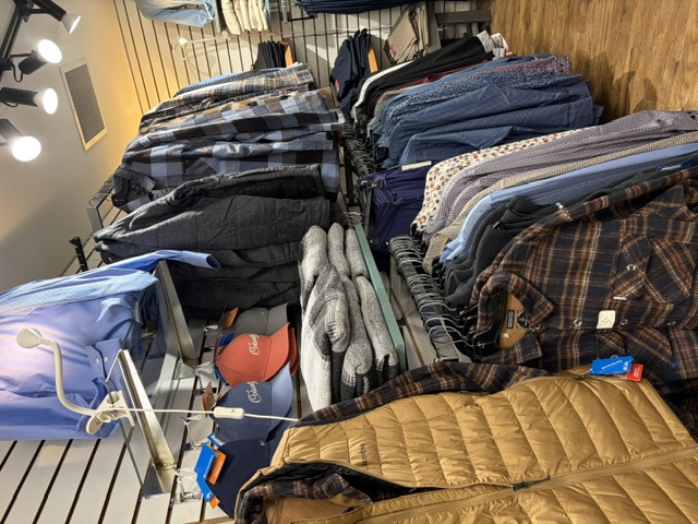 Men's flannel shirts and quilted vests on the racks
