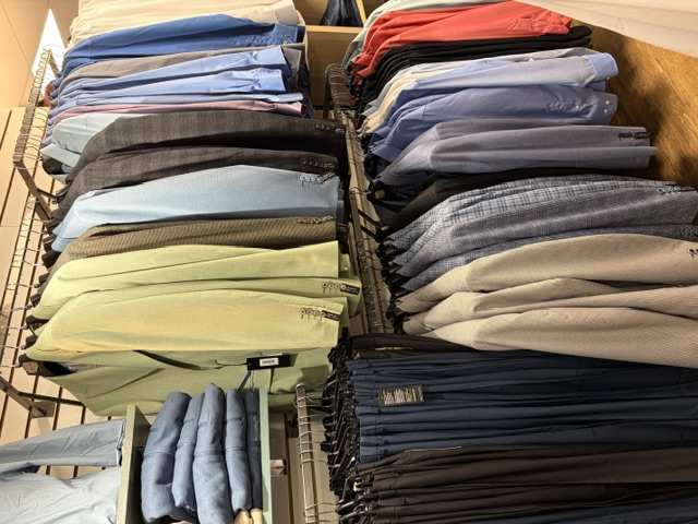 Racks of men’s sport coats and dress shirts at Trendys Clothing