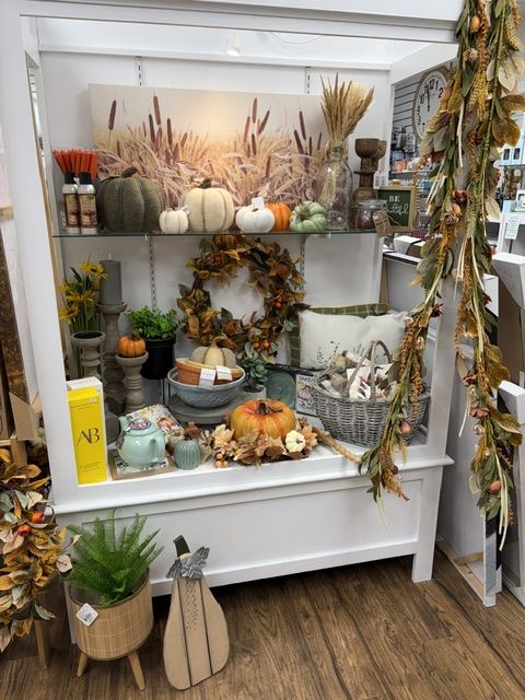 Fall décor shelves with pumpkins, wreaths, and candles at Trendys Clothing