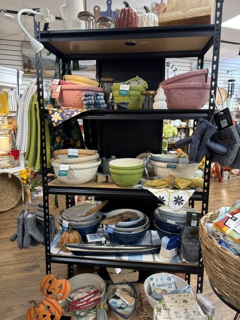 Shelves of mixing bowls, stoneware, and kitchen linens at Trendys
