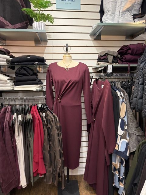 A burgundy wrap-front midi dress on display at Trendys
