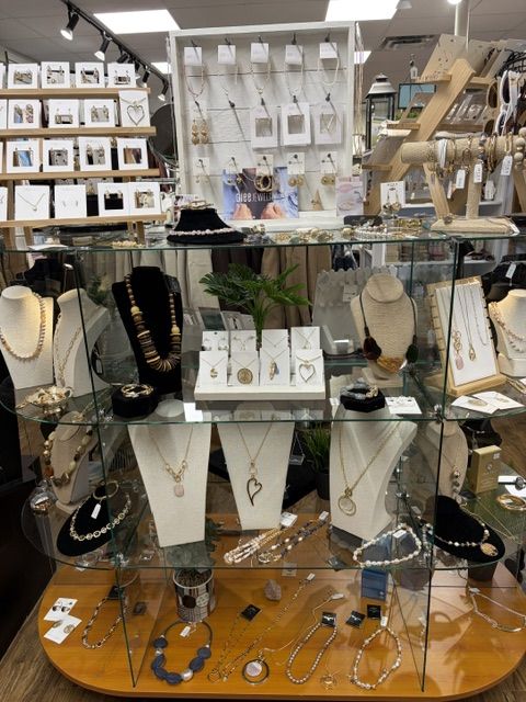 Glass jewellery case with necklaces, bracelets, and earrings at Trendys