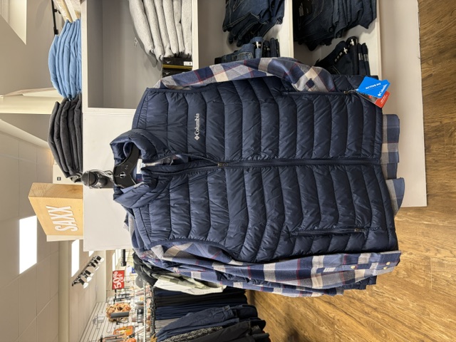 Navy Columbia puffer vest over a plaid flannel shirt