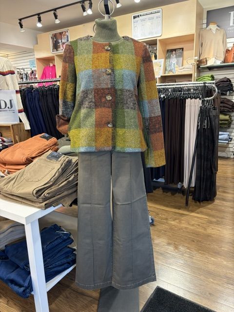 A colourful plaid jacket over a turtleneck with wide-leg trousers, styled in store at Trendys